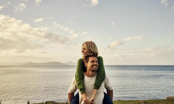 Woman and man on the beach at sunset