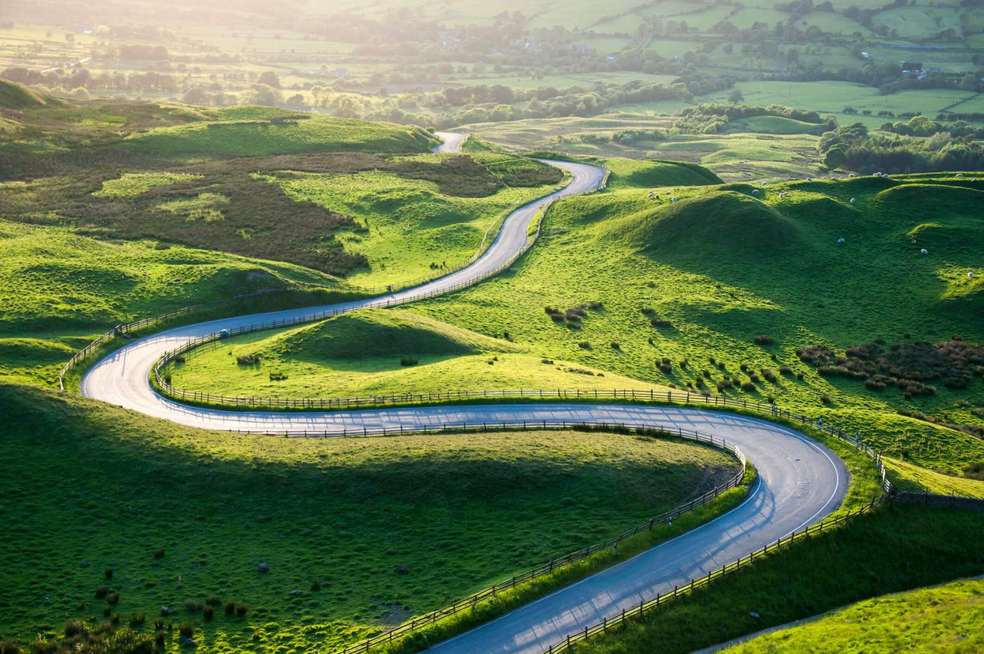 Winding road in amongst green rolling hills