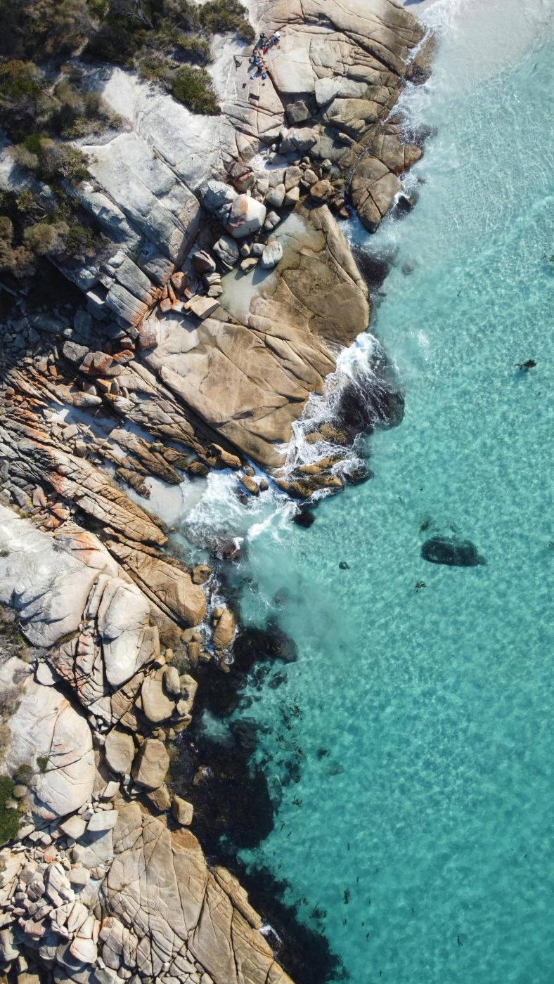 Brown rock formation near body of water during daytime photo